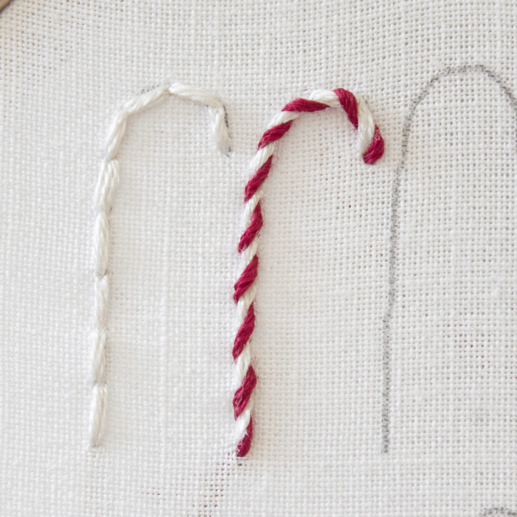 Step 6. Finish the whipped back stitch by tying off the thread in the back. The design fully resembles a red and white candy cane embroidery.